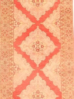 A rug with a red and white pattern on it