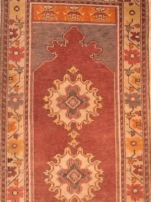 A red rug with a floral pattern on it