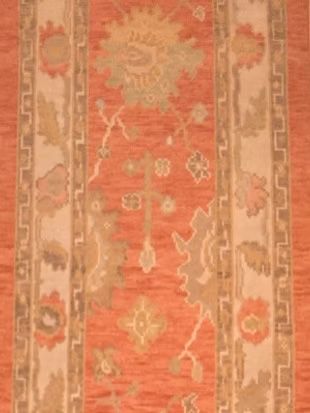 A close up of a rug with a floral pattern on it.