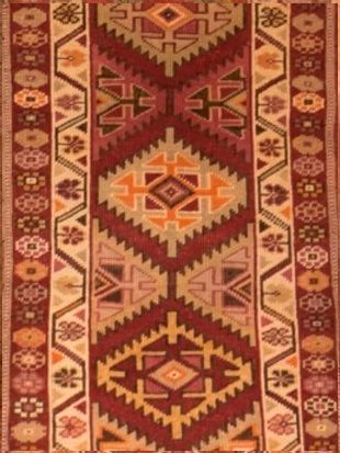A red rug with a geometric pattern on it