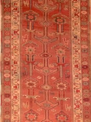 A red rug with a geometric pattern on it