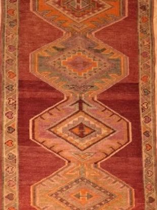 A red rug with a geometric pattern on it