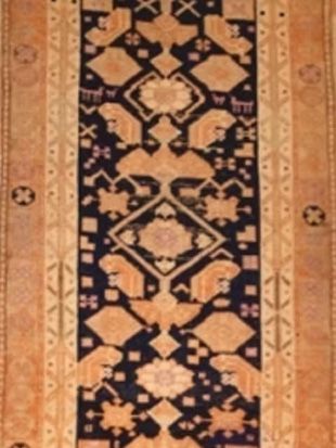 A brown and black rug with a geometric pattern
