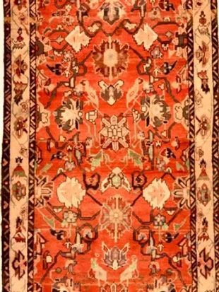 A rug with a floral pattern on it is on a white background.