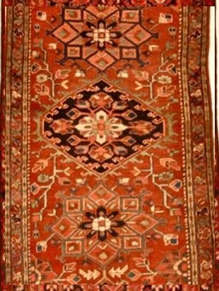 A red rug with a geometric pattern on it