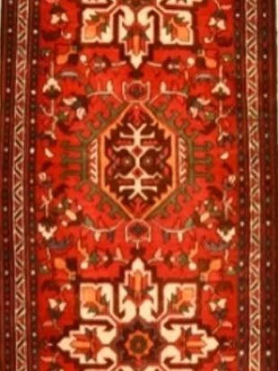 A red rug with a floral pattern on it