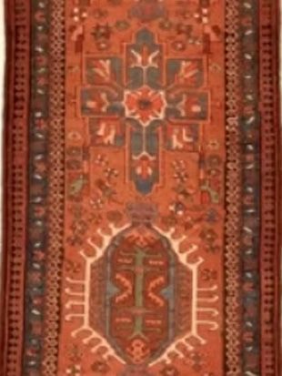 A red rug with a floral pattern on it