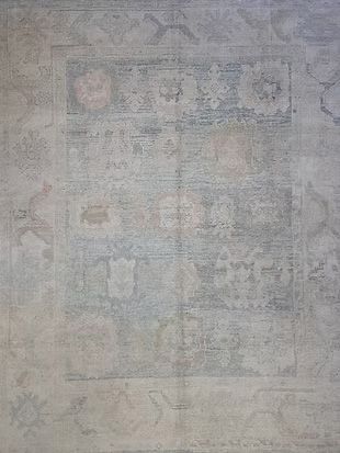 A close up of a rug on a wall with a pattern on it.