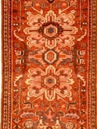 A red rug with a floral pattern on it
