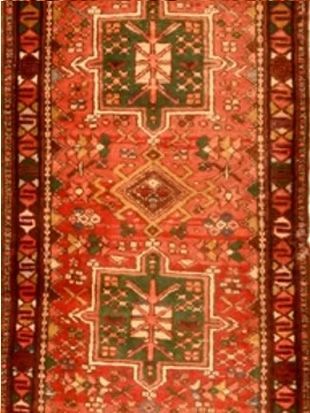 A red rug with a green and white pattern on it