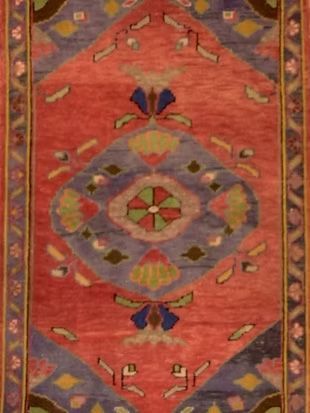 A close up of a rug with a floral pattern on it