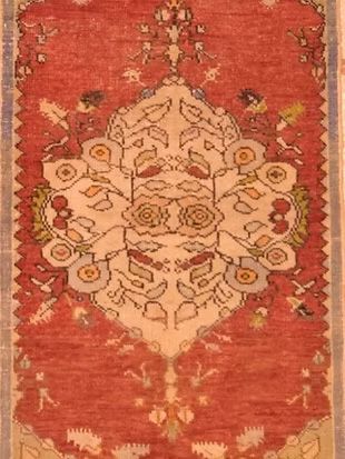 A red rug with a floral pattern on it
