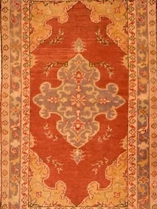 A red rug with a floral pattern on it