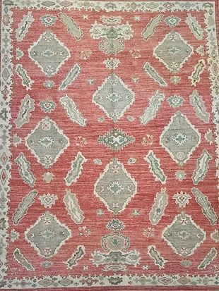 A close up of a red rug with a pattern on it.