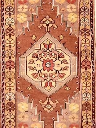 A close up of a rug with a floral pattern on it.