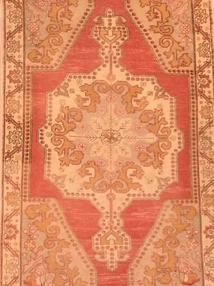 A red and white rug with a floral pattern on it