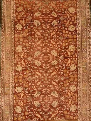 A close up of a rug with a floral pattern on it.