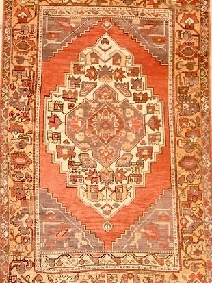 A close up of a rug with a floral pattern on it.