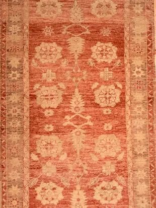 A close up of a rug with a floral pattern on it.