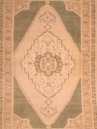 A rug with a floral pattern on it is sitting on a table.