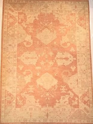 A rug with a pattern on it is hanging on a wall.