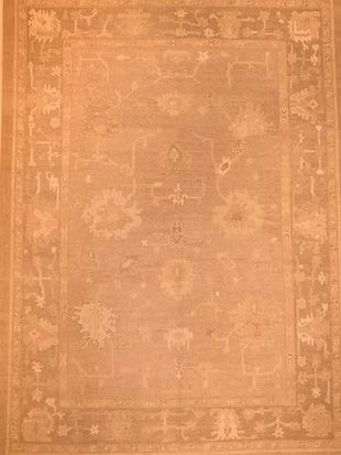 A close up of a rug with a floral pattern on it.