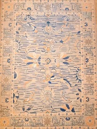 A close up of a rug with a floral pattern on it.