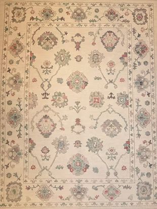A white rug with a floral pattern on it