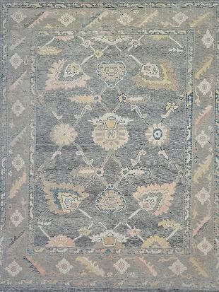 A close up of a rug with a floral pattern on it.