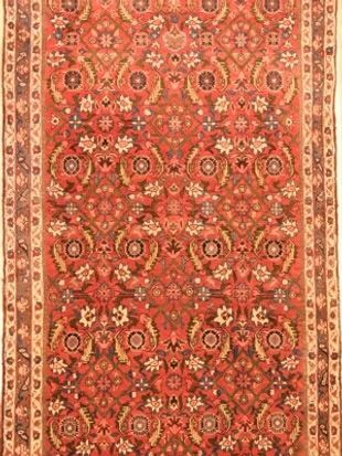 A red rug with a floral pattern on it.