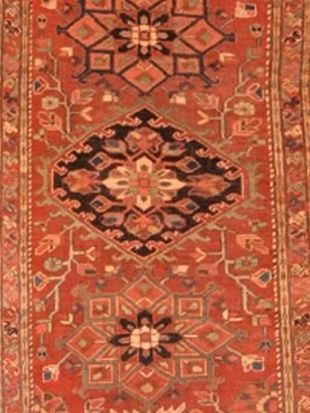 A red rug with a geometric pattern on it
