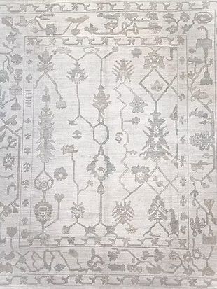 A close up of a rug with a floral pattern on it.