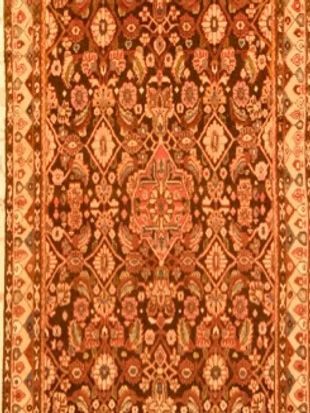 A close up of a rug with a floral pattern on it.