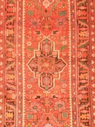 A red rug with a geometric pattern on it