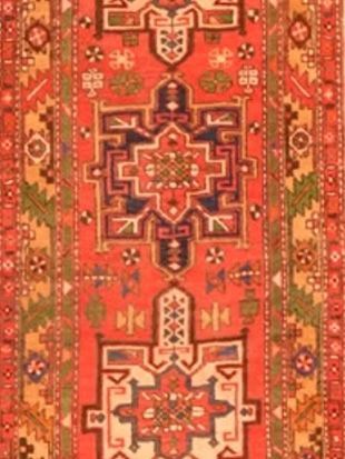 A red rug with a geometric pattern on it
