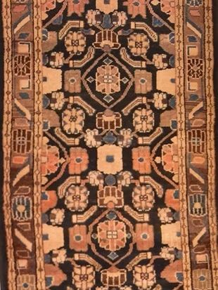 A close up of a rug with a floral pattern