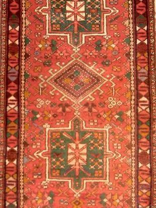 A red rug with a geometric pattern on it