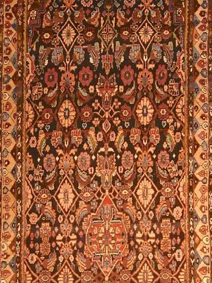 A close up of a rug with a floral pattern on it.