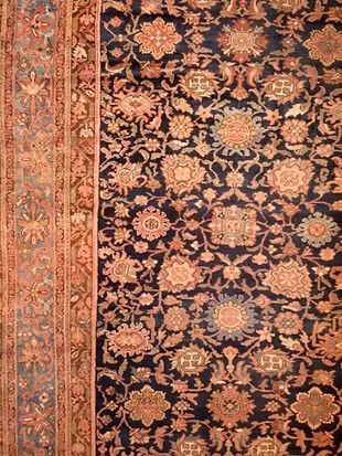 A close up of a rug with a floral pattern on it.