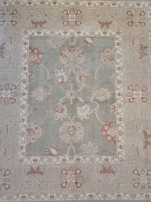A close up of a rug with a floral pattern on it.