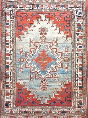 A red , white and blue rug with a geometric pattern on it.