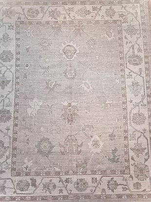 A rug with a floral pattern on it is sitting on a table.