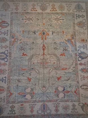 A close up of a rug with a floral pattern on it.