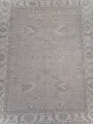 A close up of a rug with a floral pattern on it.