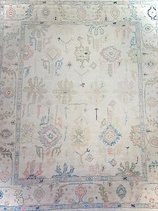 A white rug with a floral pattern on it