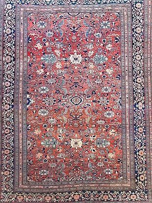 A close up of a rug with a floral pattern on it.