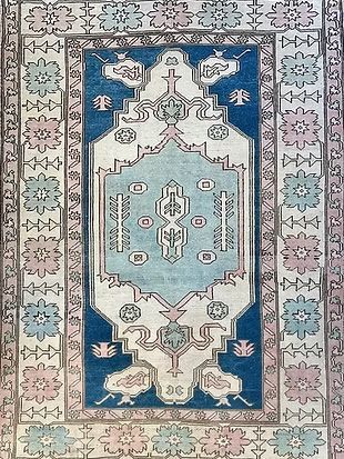 A blue and white rug with a floral pattern on it.
