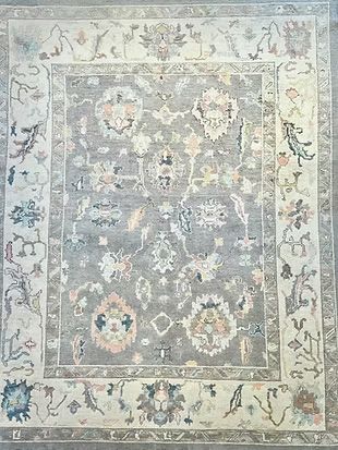 A rug with a floral pattern on it is sitting on a table.