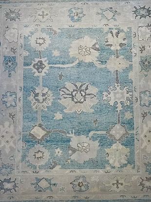 A blue and white rug with a floral pattern on it.