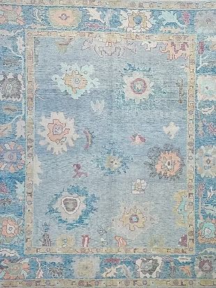 A blue rug with a floral pattern on it